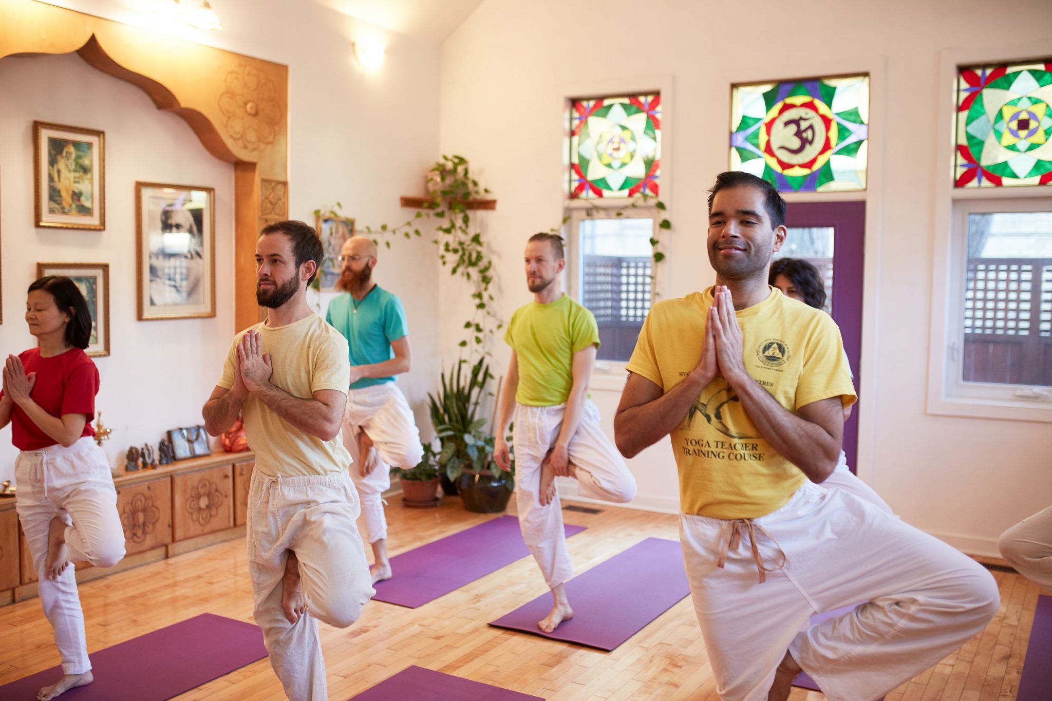 students in tree pose