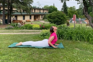 Woman practising Cobra Pose outdoors at Sivananda Yoga Canada